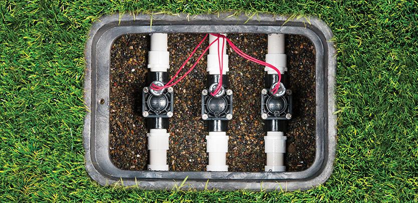 Three Hunter PGV irrigation valves wired and installed inside an in-ground valve box